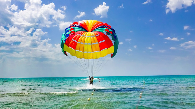 Happy,Couple,Parasailing,On,Beach,In,Summer.,Couple,Under,Parachute